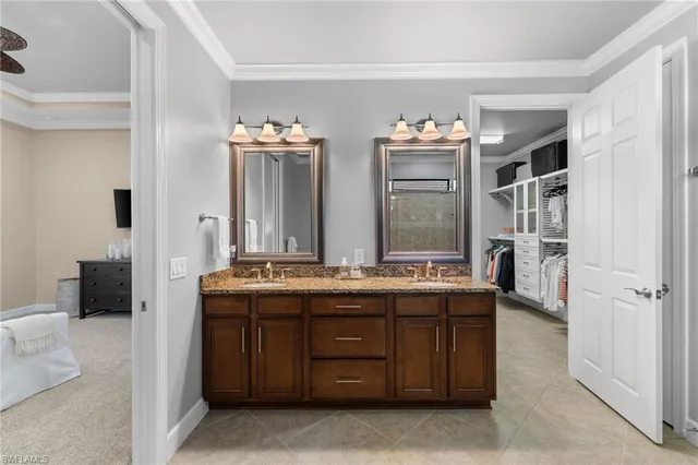 a bathroom with a granite countertop sink double vanity and a mirror