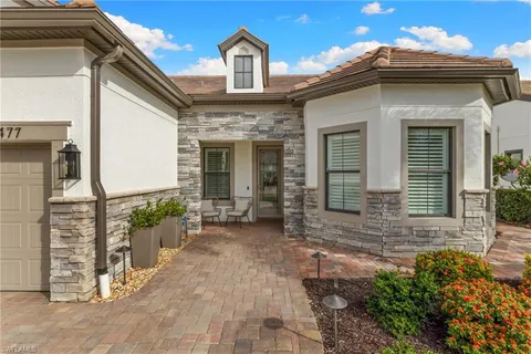 a view of a house with brick walls and potted plants