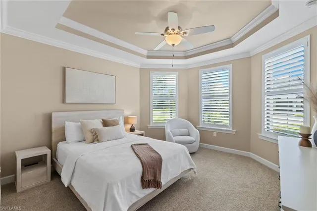 a spacious bedroom with a bed and a chandelier