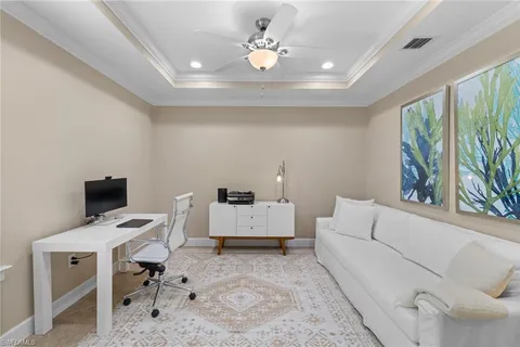 a workspace with furniture and a ceiling fan