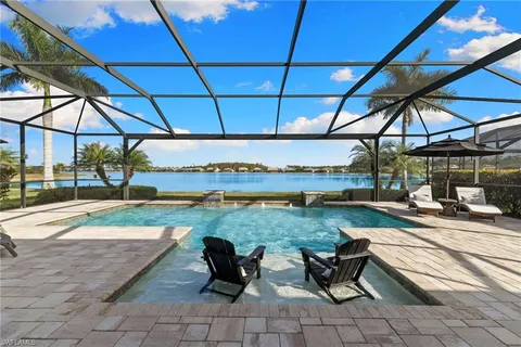 a view of a patio with table and chairs under an umbrella