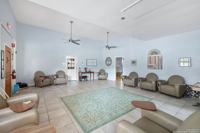 a living room with furniture and a dining table