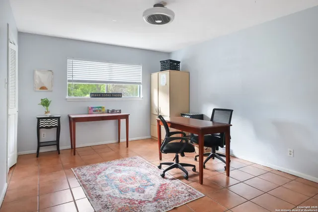 a living room with furniture and a chair