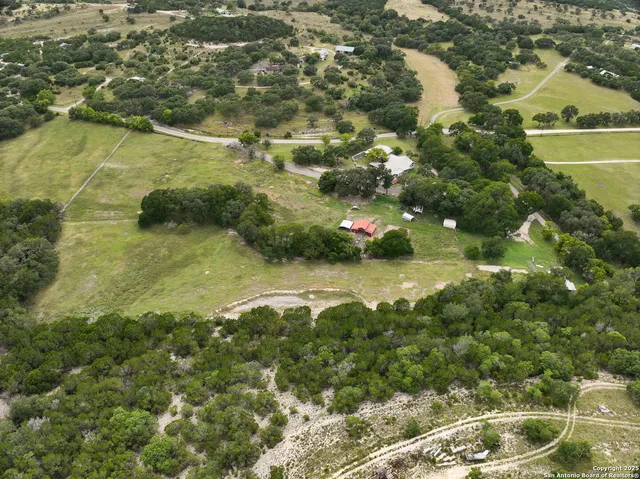 an aerial view of residential houses with outdoor space and swimming pool