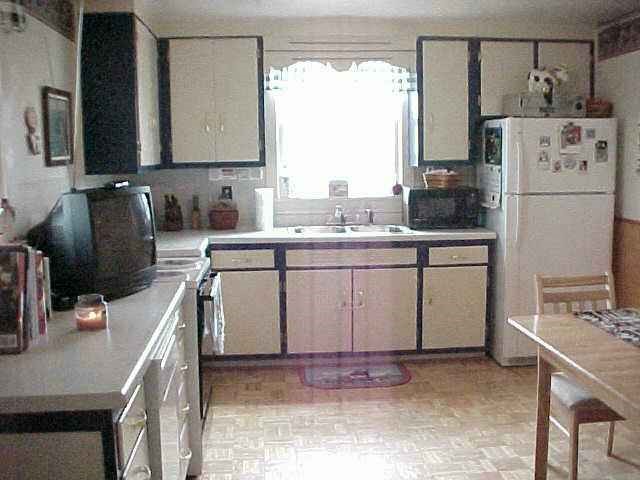 5463 West Prairie Road Shannon, IL 61078 - Photo 4 of 9 a kitchen with refrigerator cabinets and a table