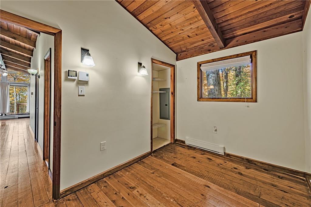 149 Maple Road Acme, PA 15610 - Photo 8 of 25 an empty room with wooden floor and windows