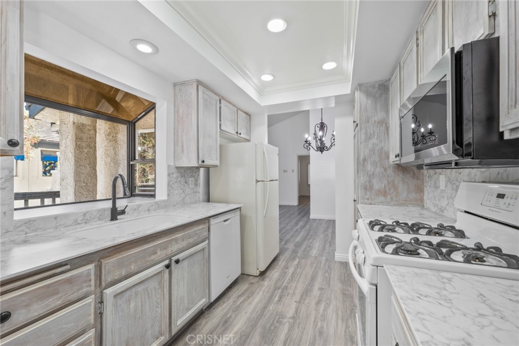 5712 Skyview Way, Unit A Agoura Hills, CA 91301 - Photo 11 of 31 a kitchen with a sink stove and refrigerator