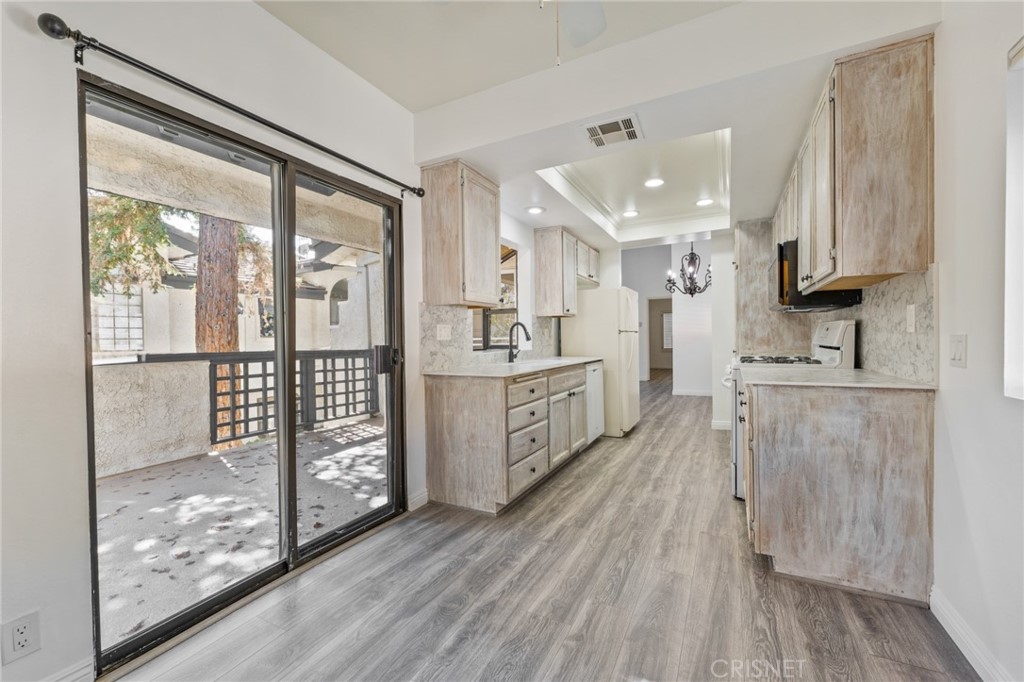 5712 Skyview Way, Unit A Agoura Hills, CA 91301 - Photo 12 of 31 a kitchen with stainless steel appliances sink cabinets and wooden floor