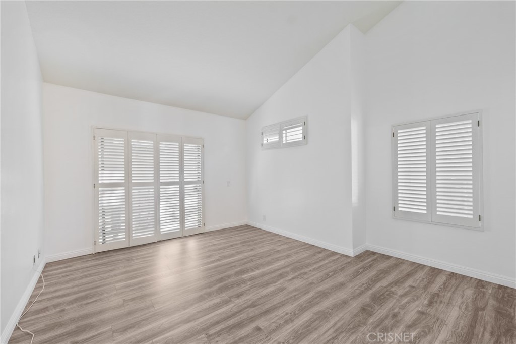 5712 Skyview Way, Unit A Agoura Hills, CA 91301 - Photo 16 of 31 an empty room with wooden floor and windows