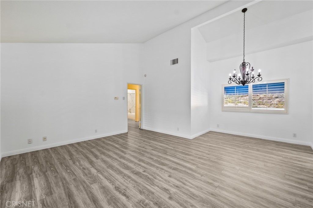 5712 Skyview Way, Unit A Agoura Hills, CA 91301 - Photo 5 of 31 a view of an empty room with window and wooden floor
