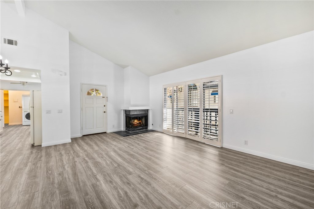 5712 Skyview Way, Unit A Agoura Hills, CA 91301 - Photo 6 of 31 an empty room with wooden floor and fireplace