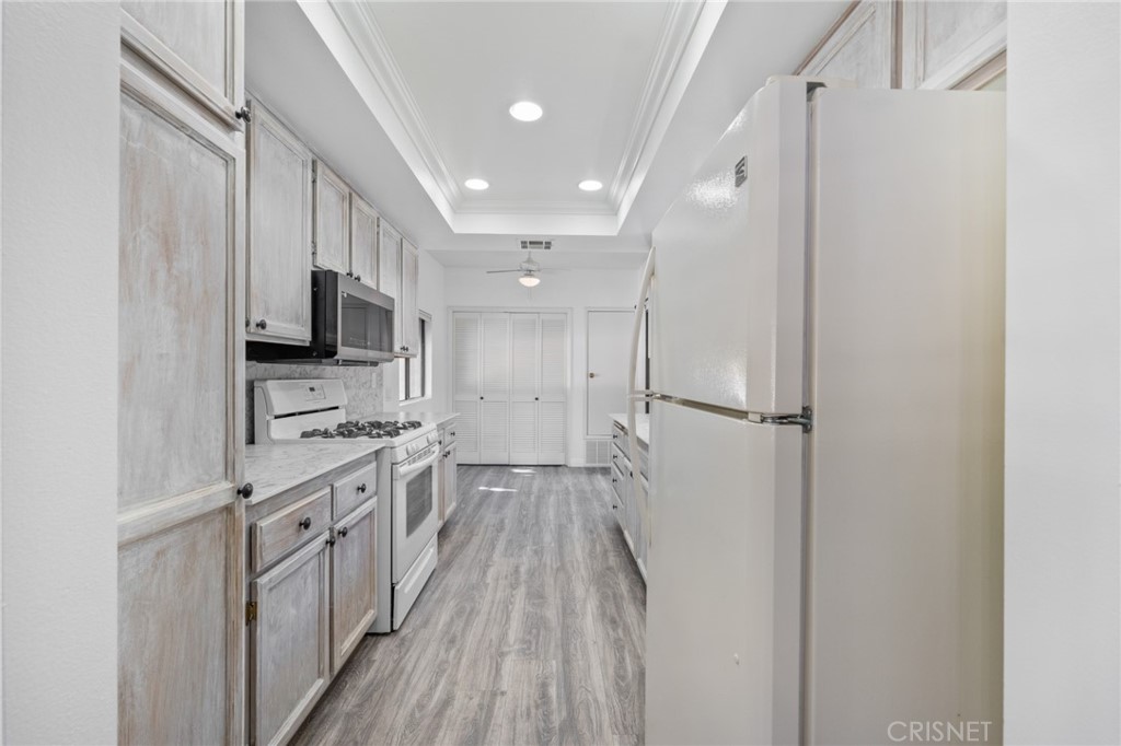 5712 Skyview Way, Unit A Agoura Hills, CA 91301 - Photo 10 of 31 a view of a kitchen with a sink and dishwasher a refrigerator with wooden floor