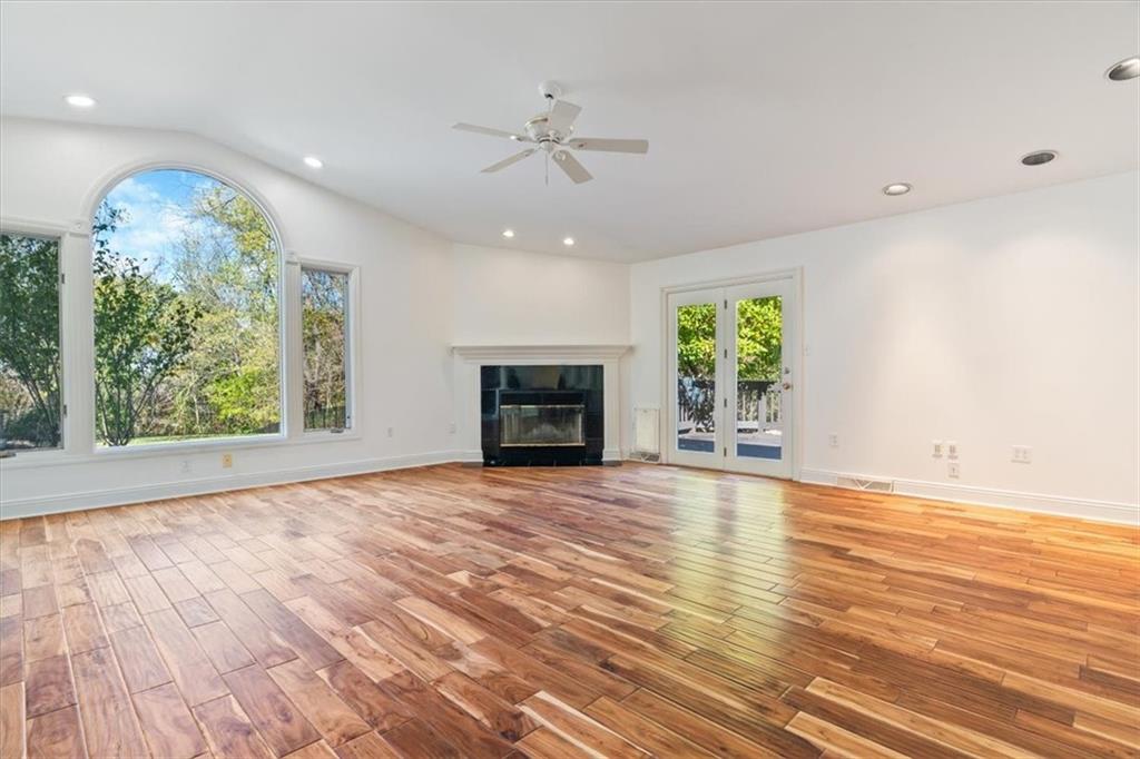 201 Dorseyville Road Pittsburgh, PA 15215 - Photo 7 of 40 an empty room with wooden floor a ceiling fan and windows