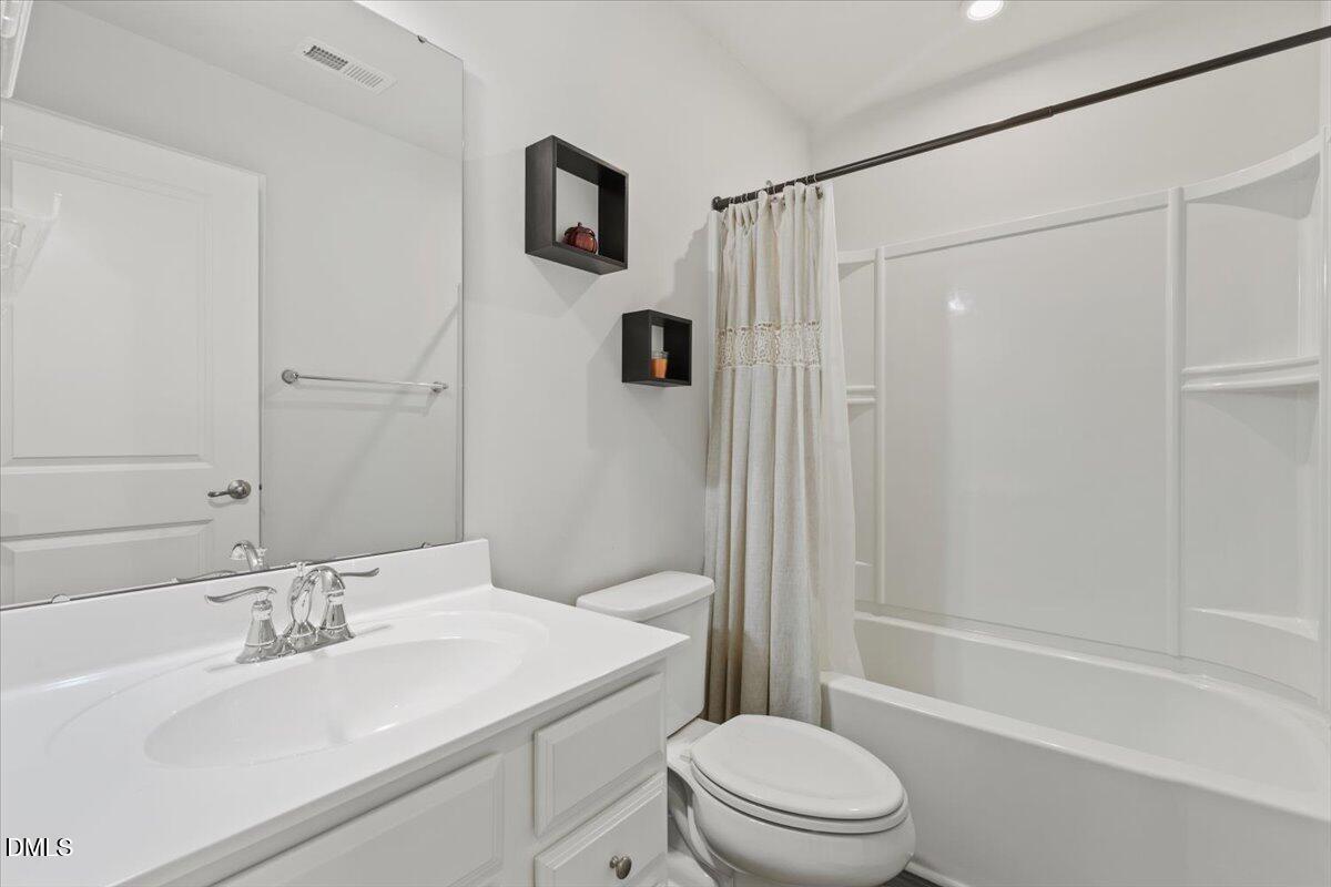 8721 Red Canyon Way Raleigh, NC 27616 - Photo 15 of 29 a bathroom with a sink a toilet and shower