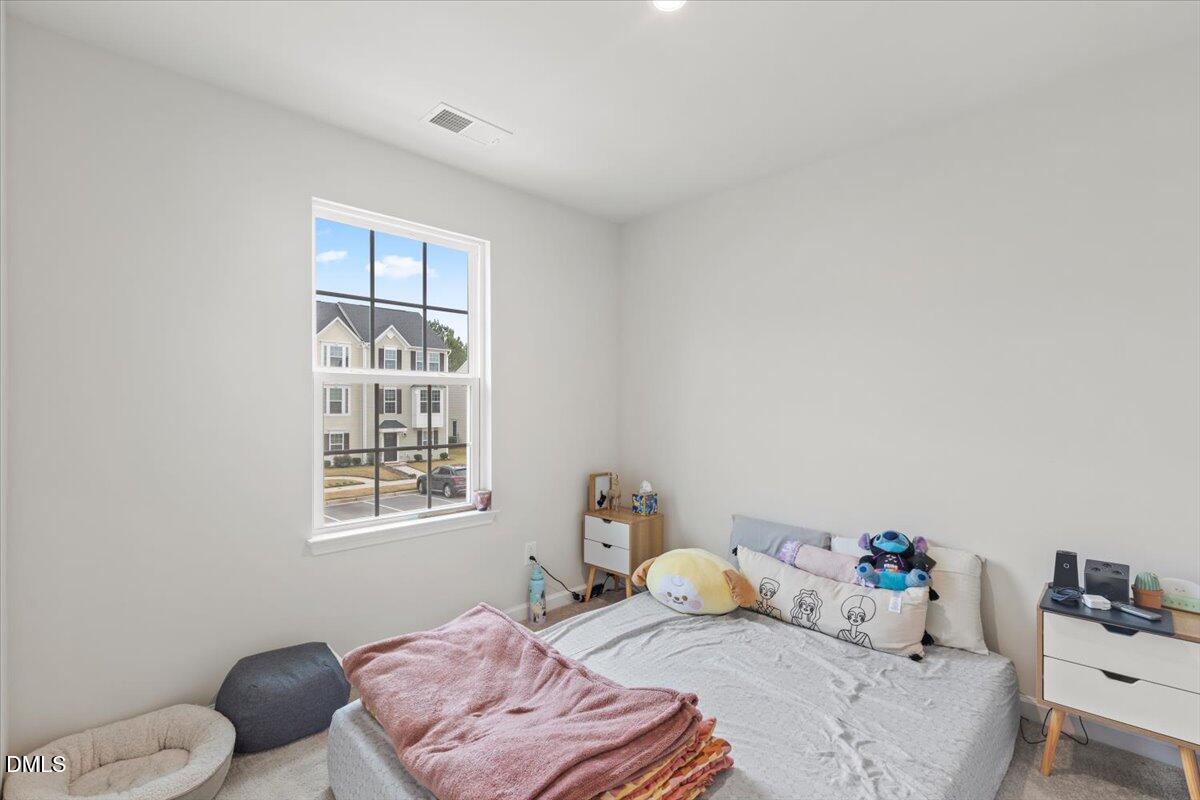 8721 Red Canyon Way Raleigh, NC 27616 - Photo 18 of 29 a bedroom with a bed and wooden floor