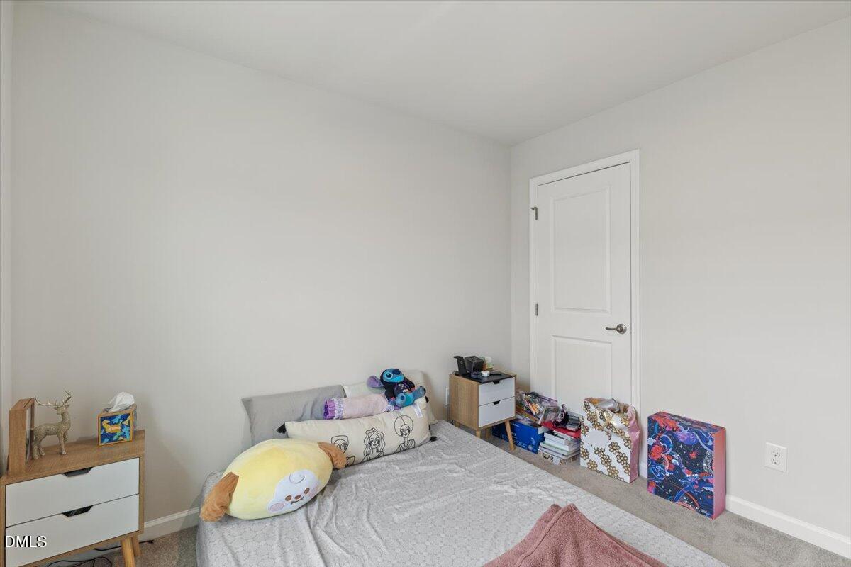 8721 Red Canyon Way Raleigh, NC 27616 - Photo 19 of 29 a bedroom with furniture and a wooden floor