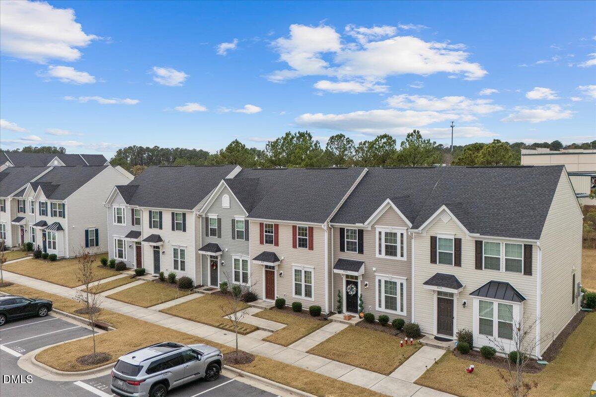 8721 Red Canyon Way Raleigh, NC 27616 - Photo 27 of 29 a view of a white house with a big yard and large tree
