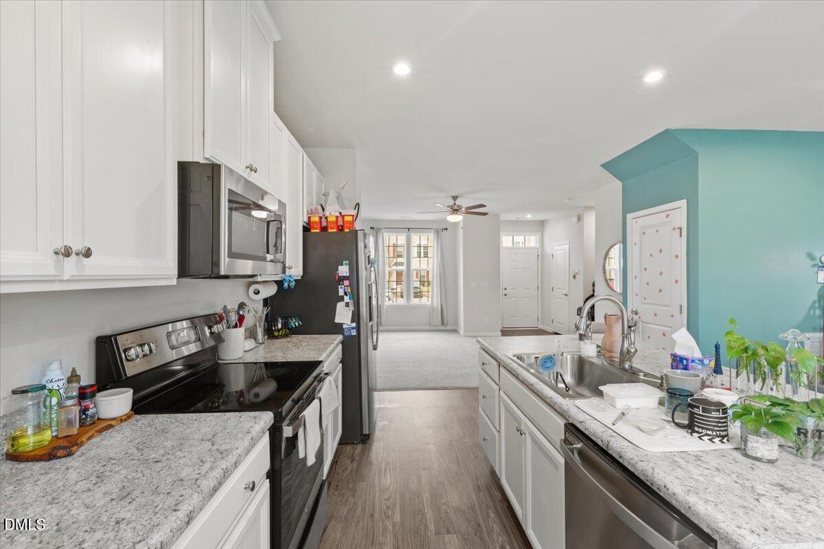8721 Red Canyon Way Raleigh, NC 27616 - Photo 6 of 29 a kitchen with sink stove and cabinets