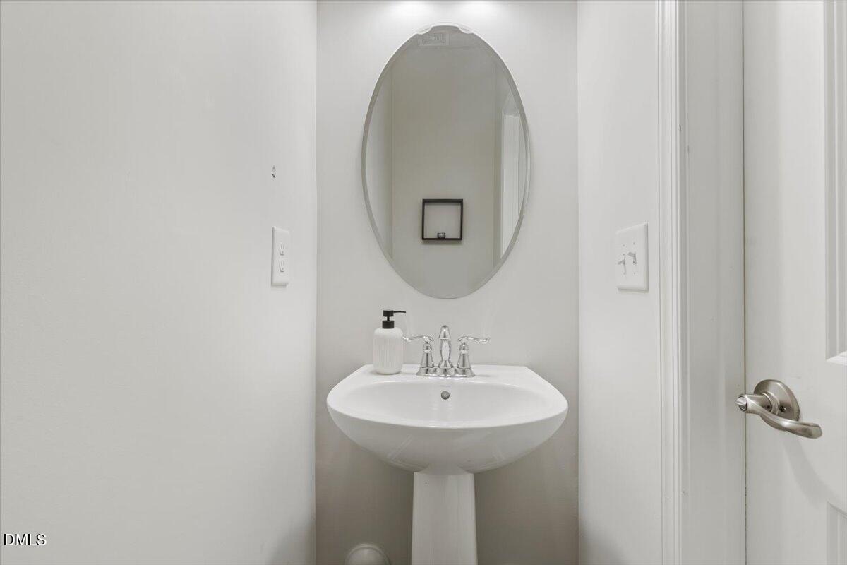 8721 Red Canyon Way Raleigh, NC 27616 - Photo 9 of 29 a bathroom with a sink and a mirror