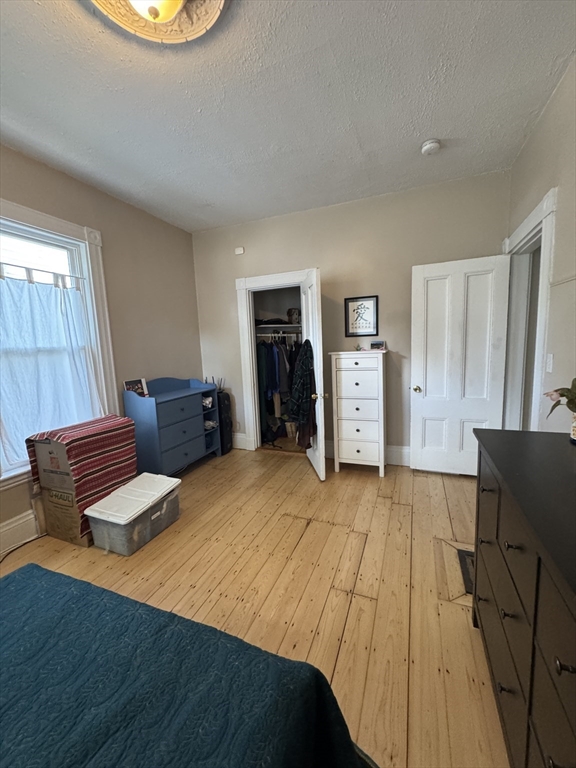 5 Spring Park Avenue, Unit 1 Boston, MA 02130 - Photo 12 of 24 a bedroom with a bed and wooden floor