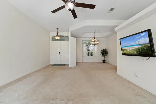 a kitchen with stainless steel appliances granite countertop a stove top oven a sink a refrigerator and white cabinets