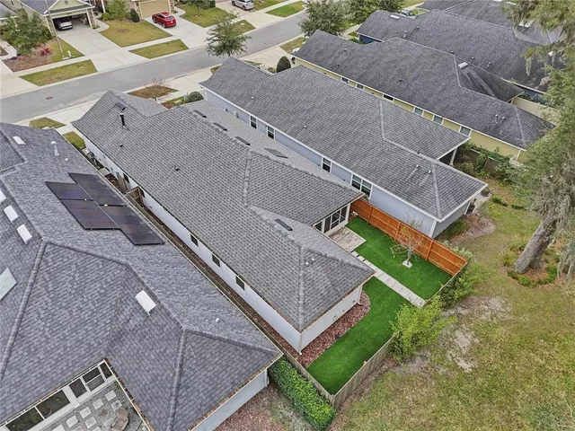 an aerial view of a house with a yard