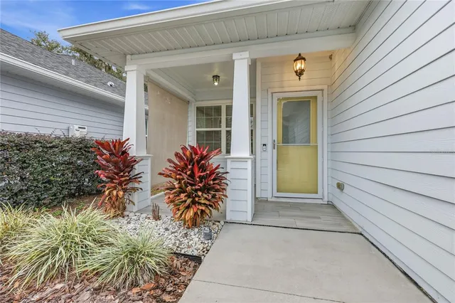 a entryway view with a potted plant in front of door