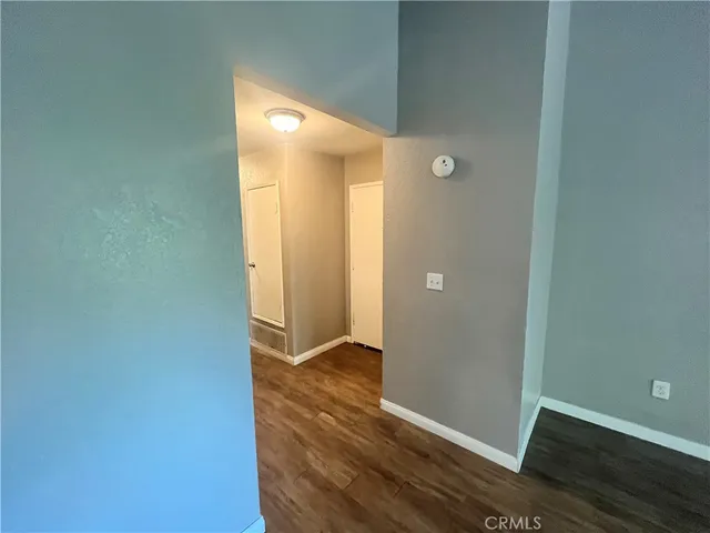 a view of hallway with wooden floor