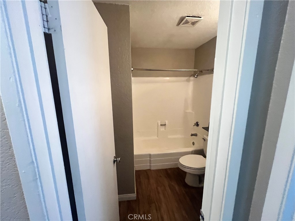 600 Central Avenue, Unit 302 Riverside, CA 92507 - Photo 13 of 27 a bathroom with a granite countertop sink toilet and shower