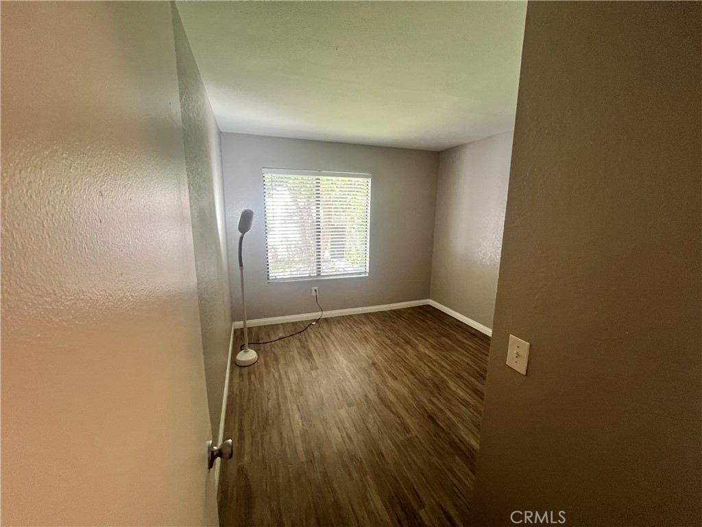 600 Central Avenue, Unit 302 Riverside, CA 92507 - Photo 15 of 27 an empty room with wooden floor and windows