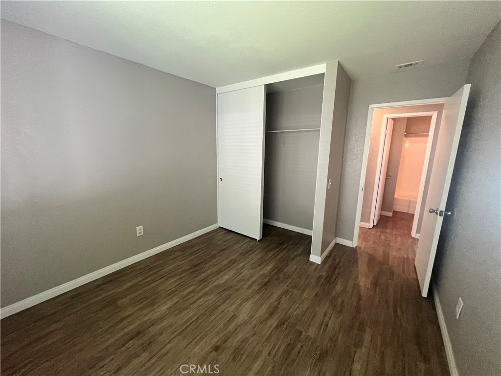 600 Central Avenue, Unit 302 Riverside, CA 92507 - Photo 16 of 27 a view of an empty room with wooden floor and a window