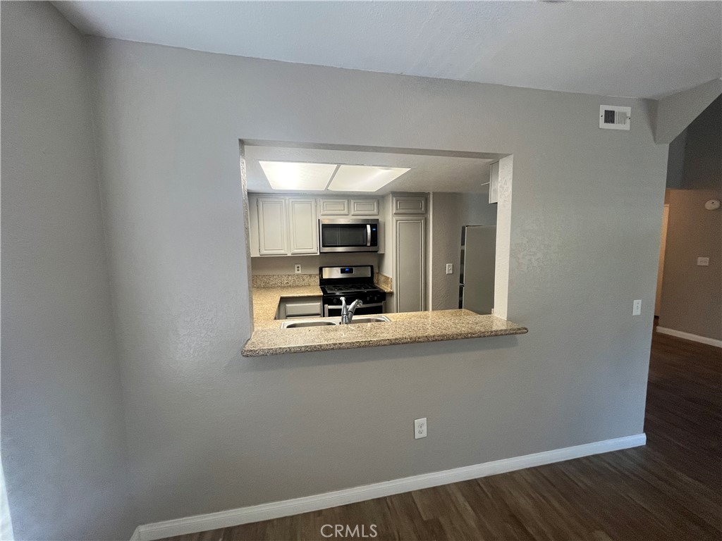 600 Central Avenue, Unit 302 Riverside, CA 92507 - Photo 6 of 27 a view of kitchen with wooden floor