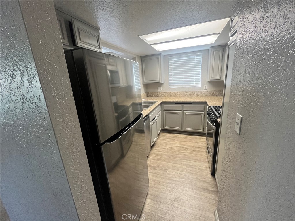 600 Central Avenue, Unit 302 Riverside, CA 92507 - Photo 8 of 27 a bathroom with a sink a toilet a mirror and window