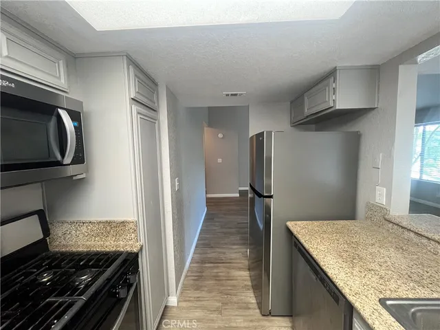 an empty room with wooden floor and entrance