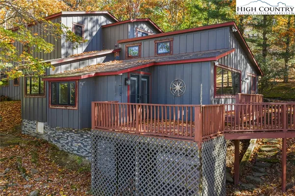 a view of a house with a small yard and wooden fence
