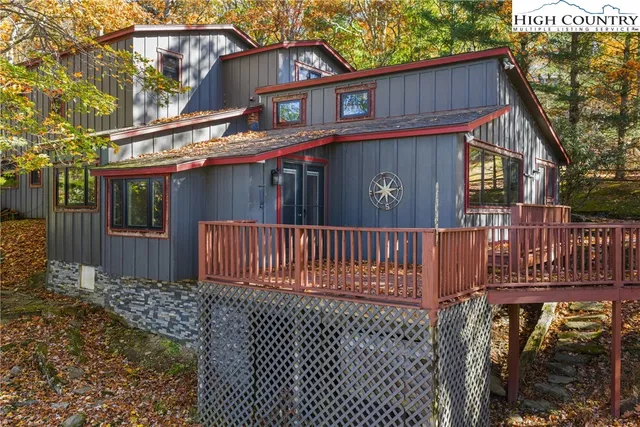 a view of a house with a small yard and wooden fence