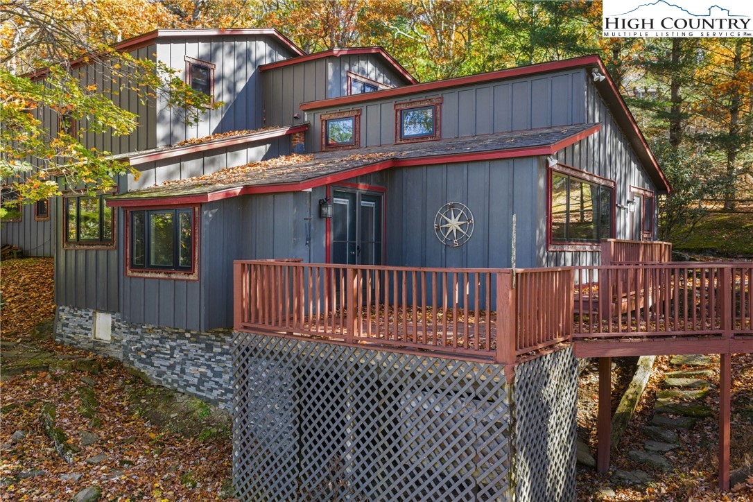 a view of a house with a small yard and wooden fence