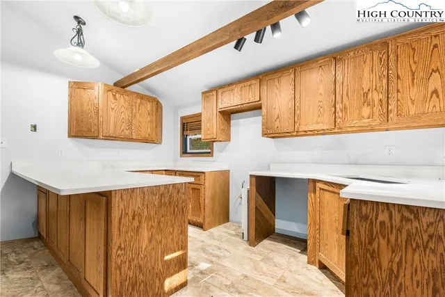 a kitchen with a sink a stove and a refrigerator