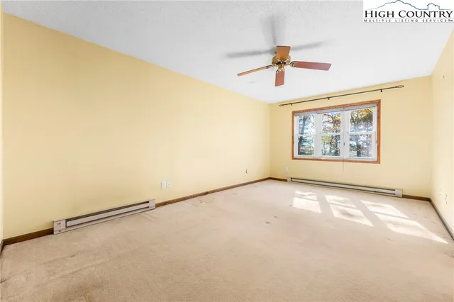 a view of empty room with ceiling fan