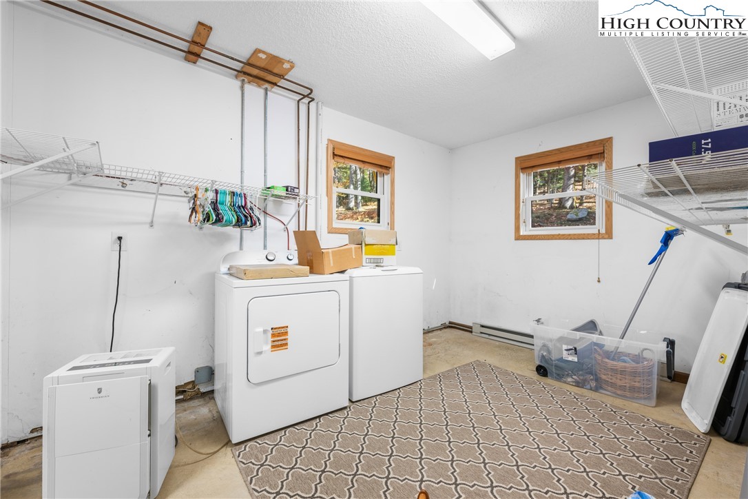 615 Sampson Road Boone, NC 28607 - Photo 29 of 36 a room with a washing machine and a wooden floor