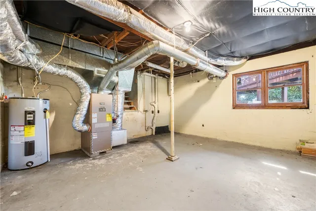 a backyard of a house with trees and outdoor seating