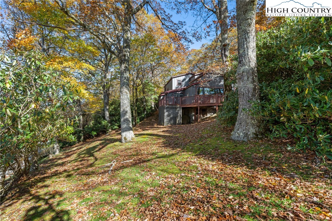 615 Sampson Road Boone, NC 28607 - Photo 34 of 36 a backyard of a house with trees and outdoor seating