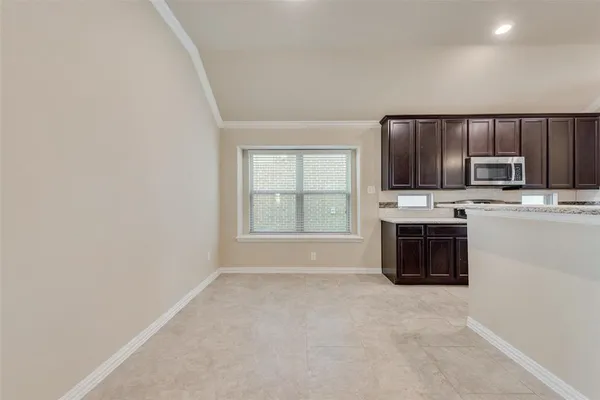 a kitchen with stainless steel appliances a stove sink and microwave