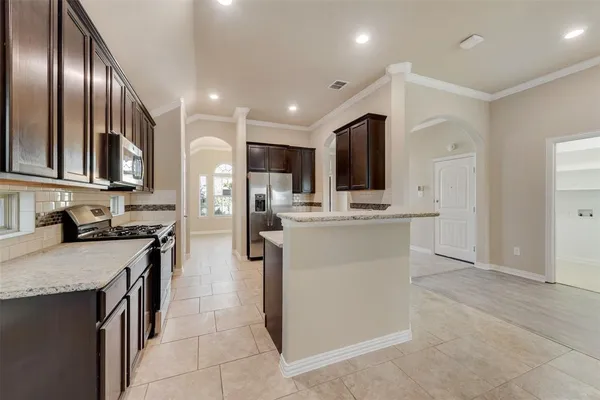 a kitchen with cabinets and stainless steel appliances