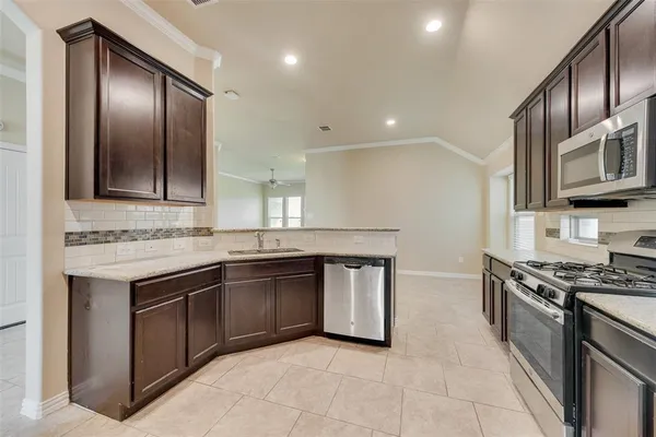 a kitchen with stainless steel appliances granite countertop a stove and a sink