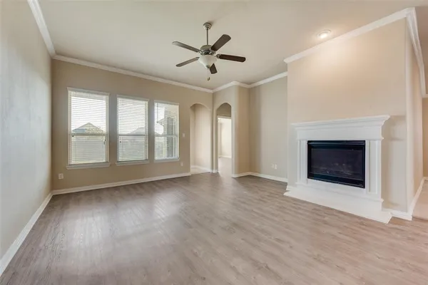wooden floor in an empty room with a fireplace