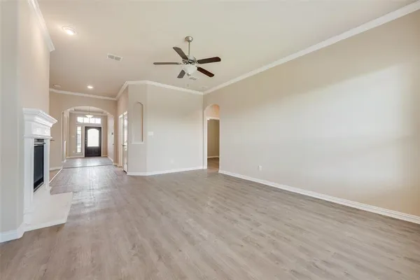a view of a hallway with wooden floor and a ceiling fan
