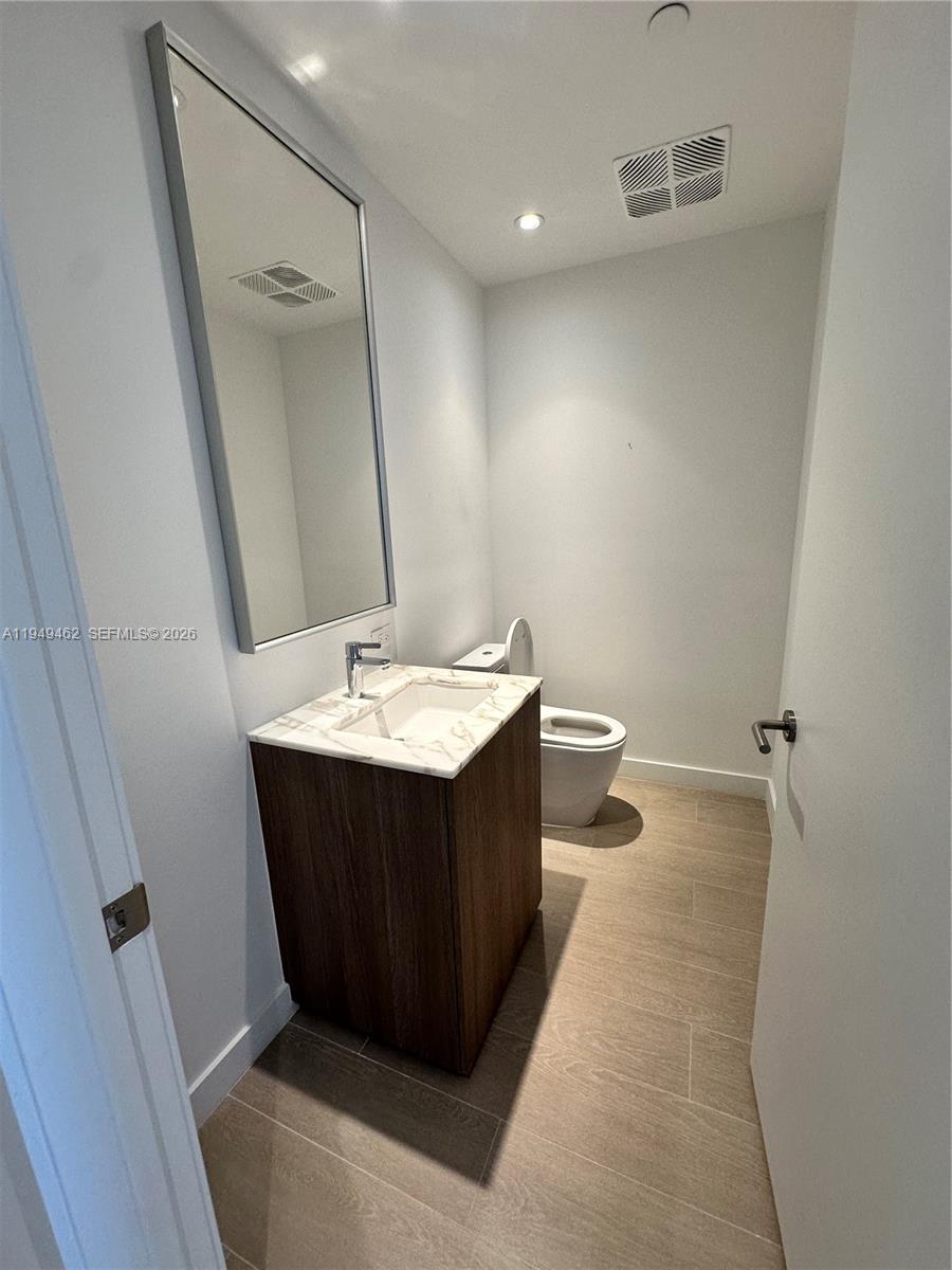 500 Alton Road, Unit 1408 Miami Beach, FL 33139 - Photo 11 of 21 a bathroom with a sink vanity and mirror