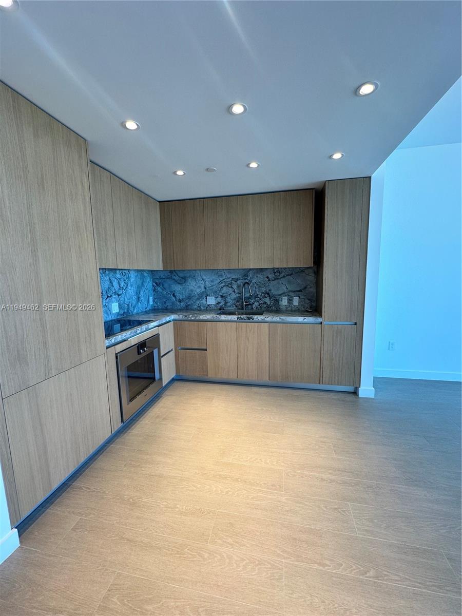 500 Alton Road, Unit 1408 Miami Beach, FL 33139 - Photo 13 of 21 a kitchen with a sink and cabinets