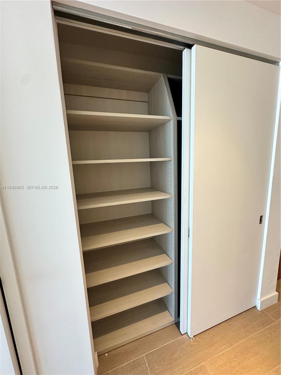 500 Alton Road, Unit 1408 Miami Beach, FL 33139 - Photo 17 of 21 a view of walk in closet with empty racks